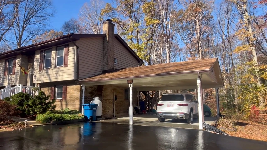 Split level home with a freshly cleaned carport and concrete driveway